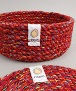 A close up view of the Respiin multicoloured recycled cotton coaster holder showing the weave detail and brand patch stitched on the rim
