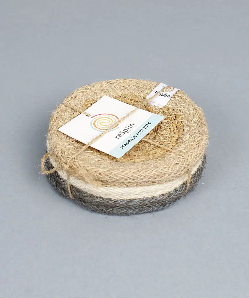 Stack of 6 ReSpiin natural jute coasters held by yarn