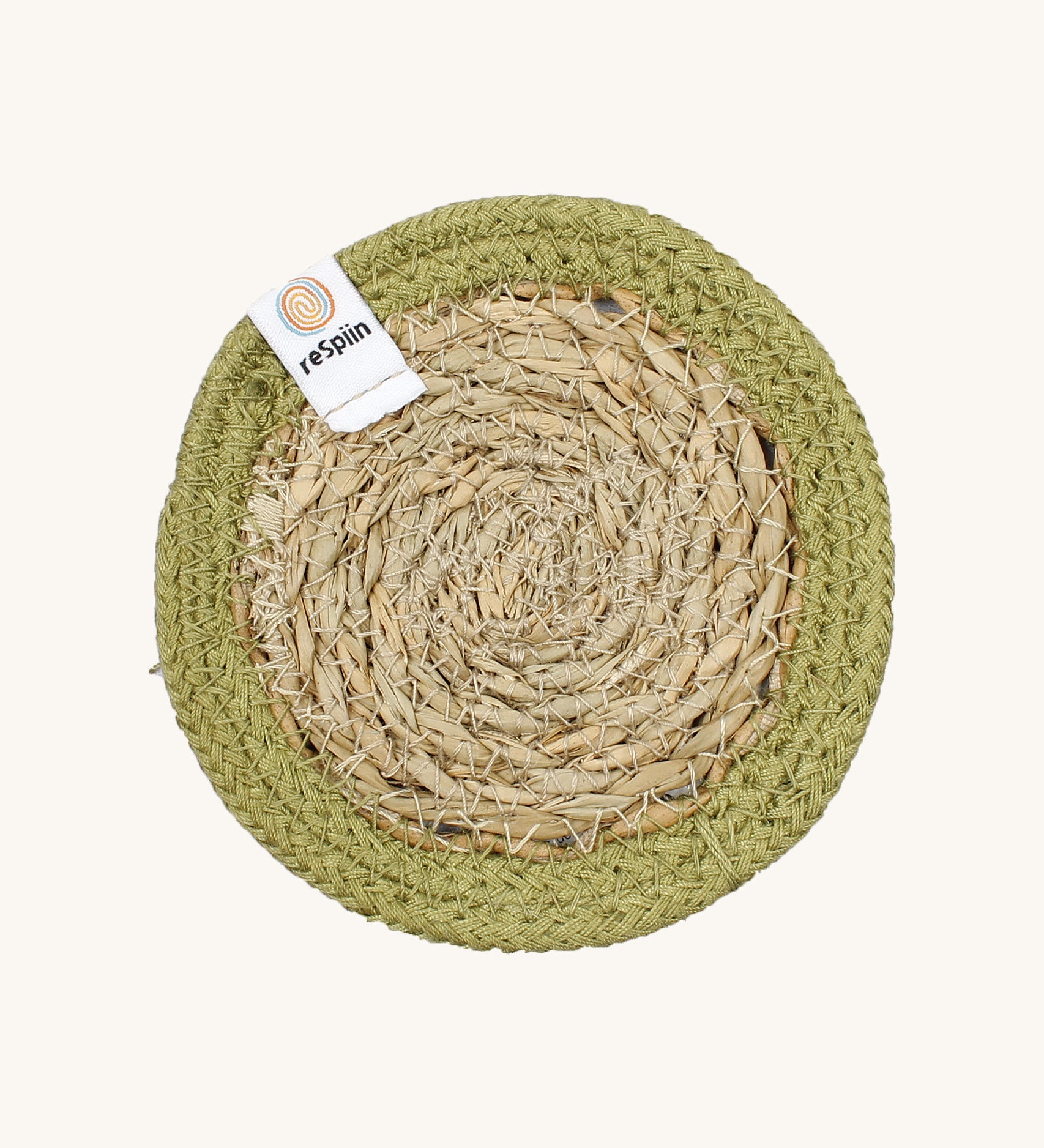 The ReSpiin natural jute and seagrass coaster in green.