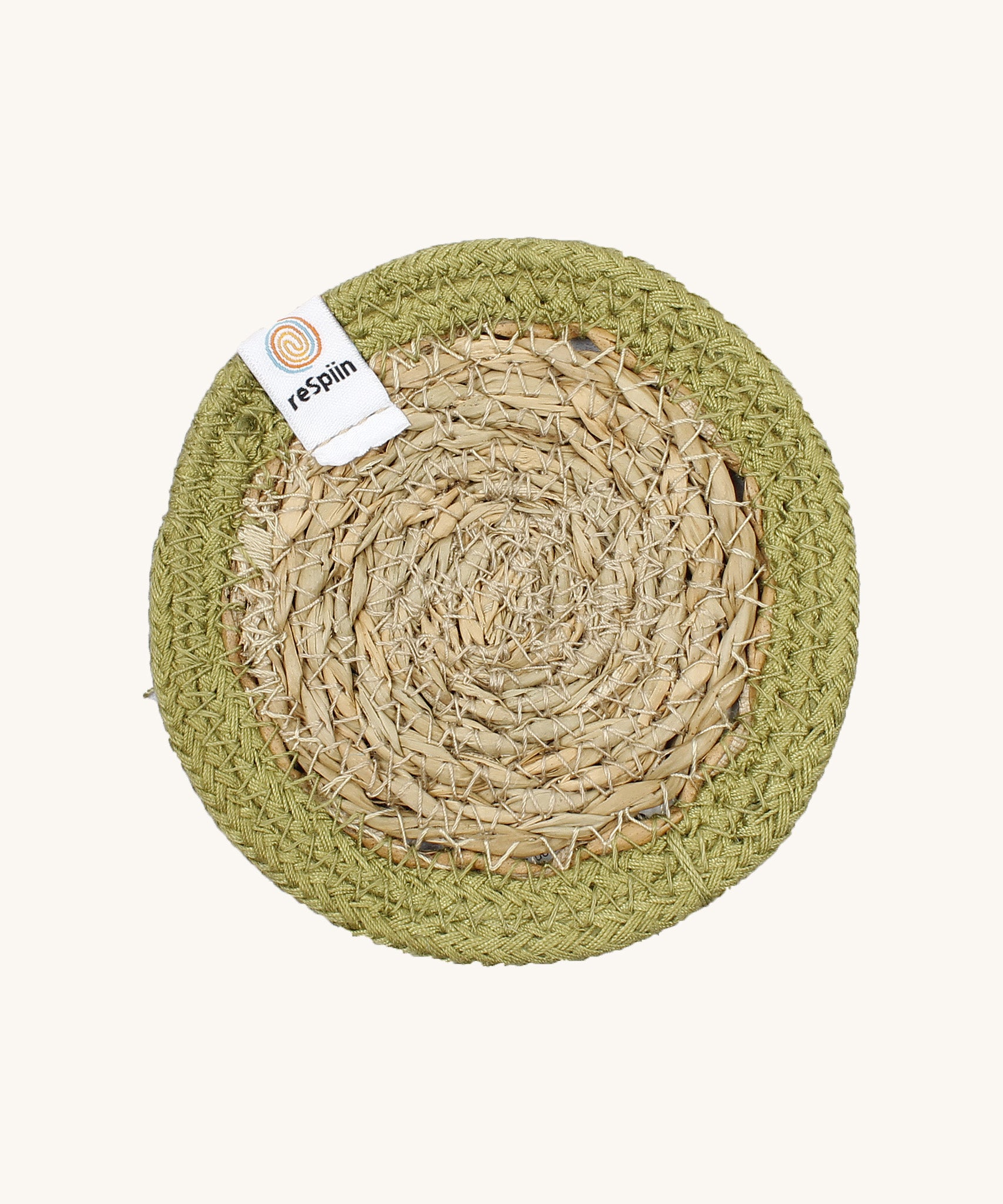 The ReSpiin natural jute and seagrass coaster in green.