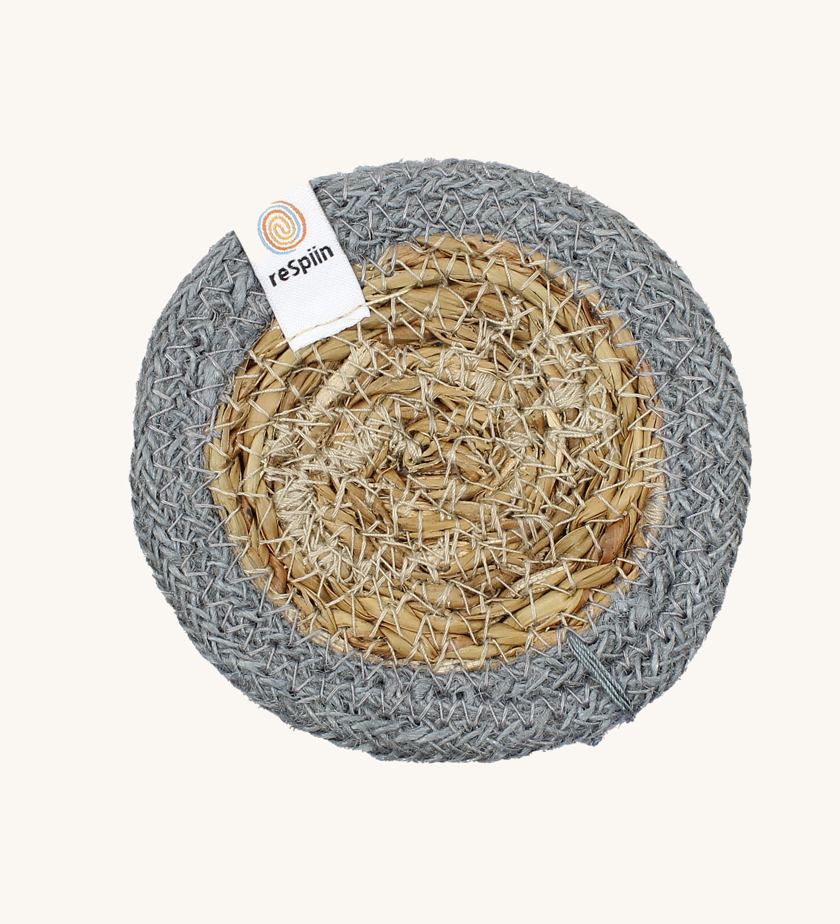 The ReSpiin natural jute and seagrass coaster in grey.