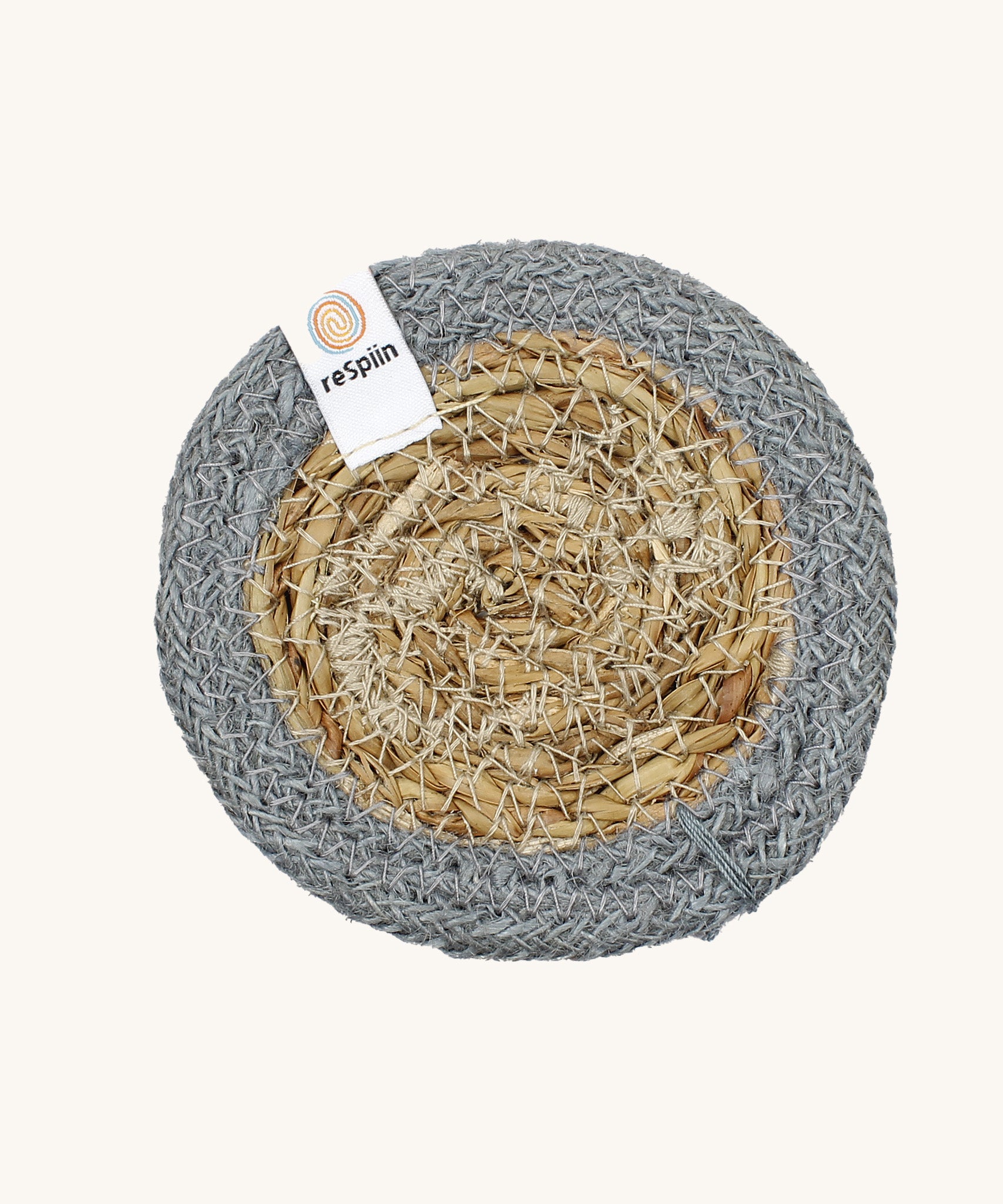 The ReSpiin natural jute and seagrass coaster in grey.