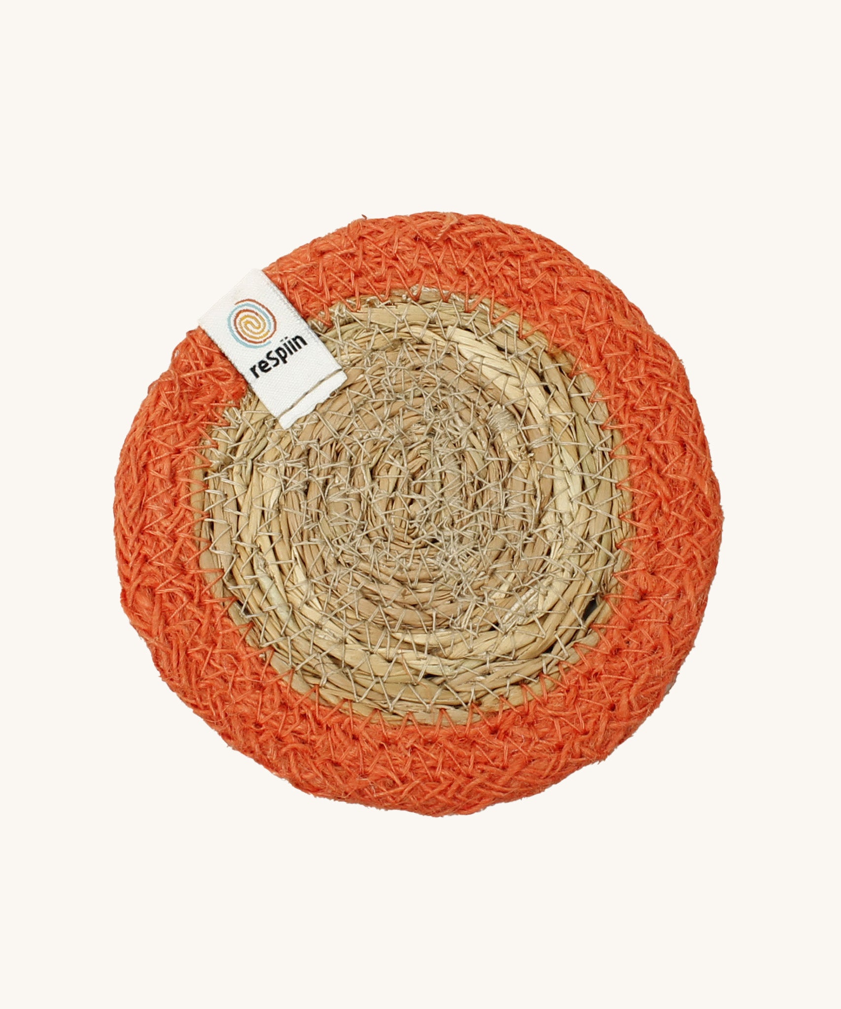 The ReSpiin natural jute and seagrass coaster in orange.