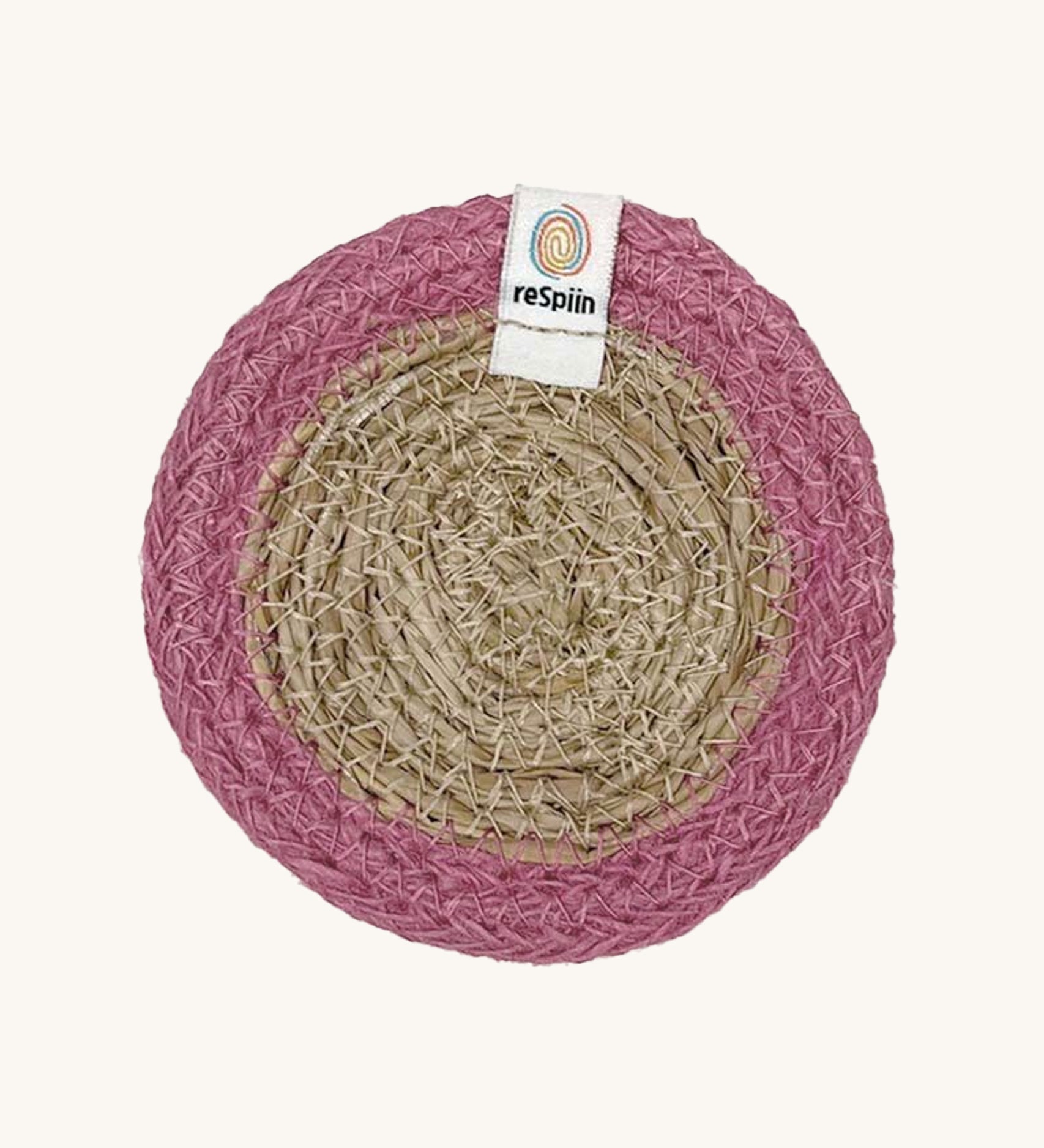 The ReSpiin natural jute and seagrass coaster in pink.