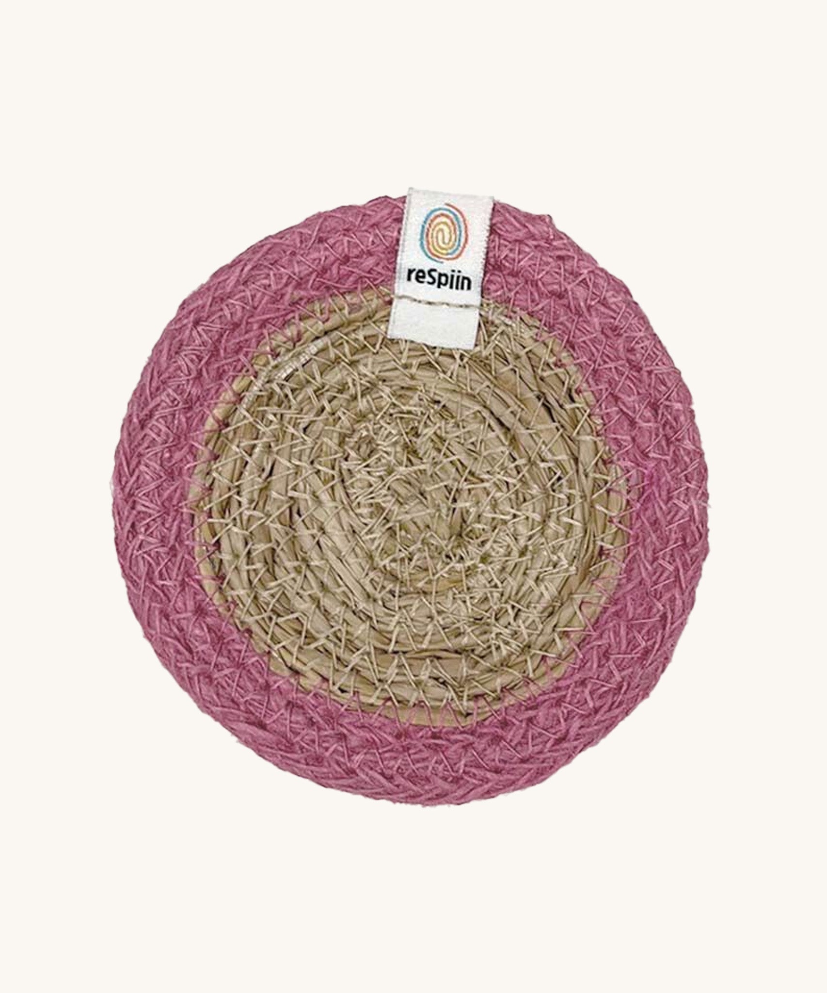 The ReSpiin natural jute and seagrass coaster in pink.