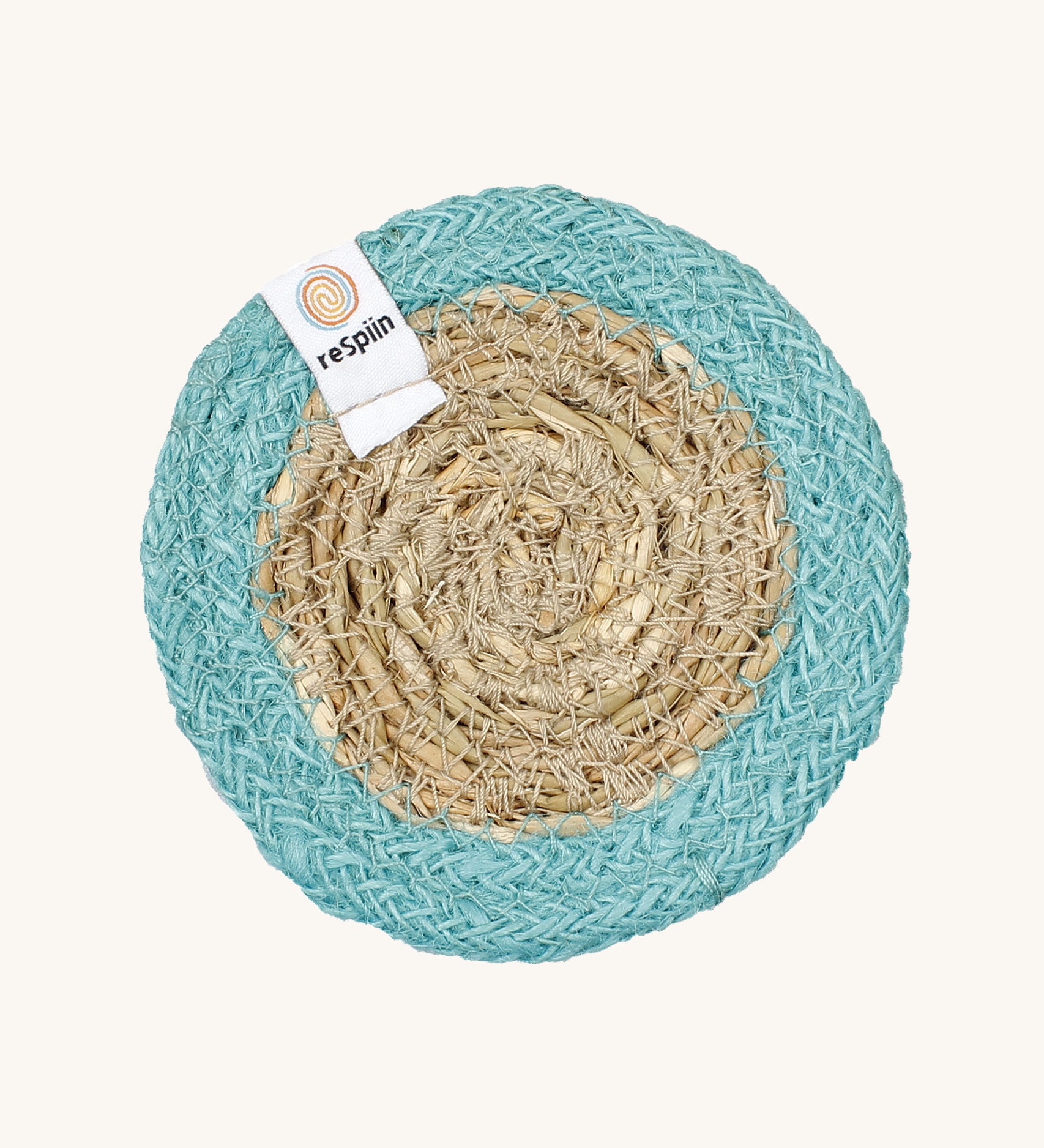 The ReSpiin natural jute and seagrass coaster in turquoise.