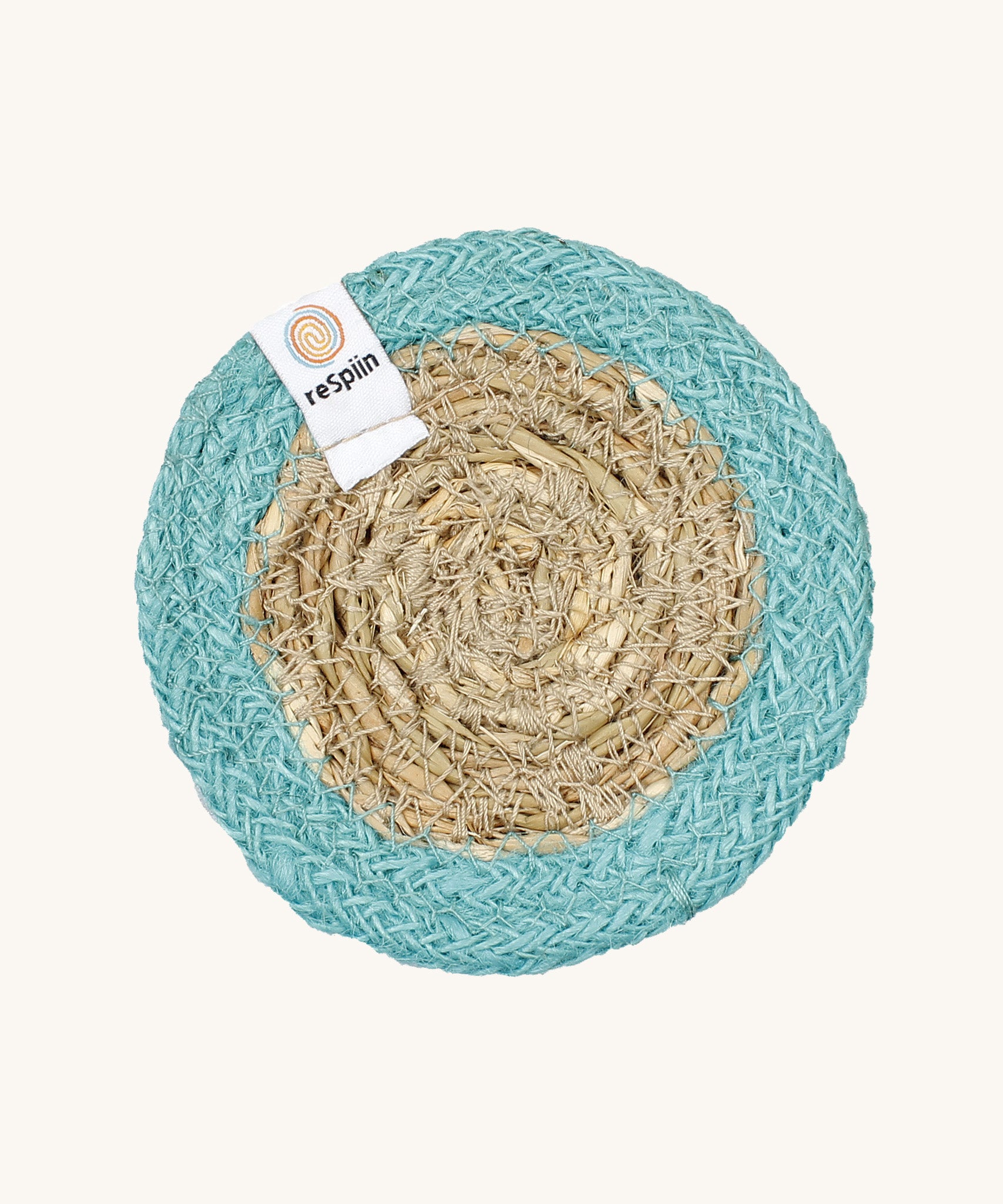 The ReSpiin natural jute and seagrass coaster in turquoise.