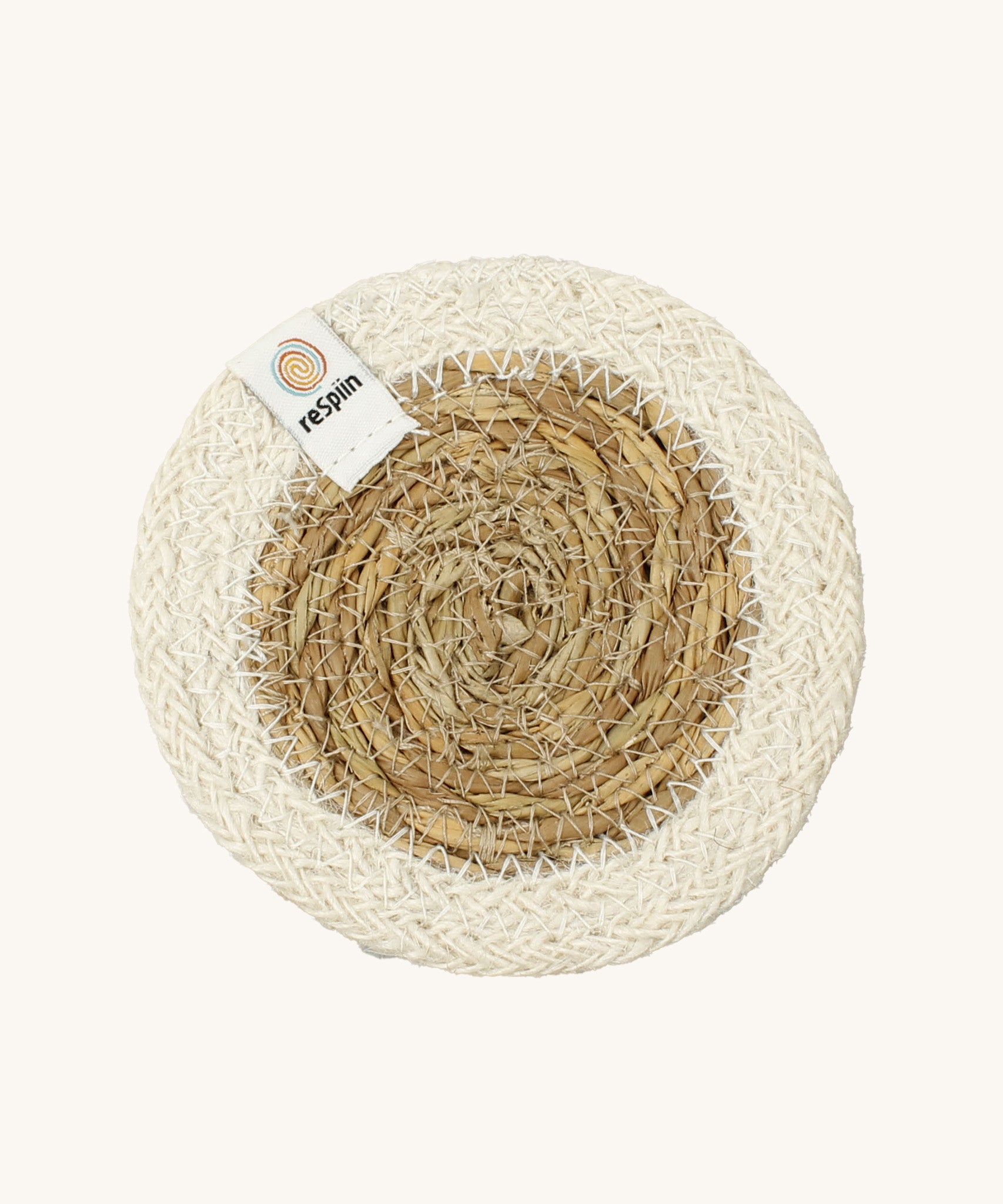 The ReSpiin natural jute and seagrass coaster in white.