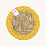 The ReSpiin natural jute and seagrass coaster in yellow.