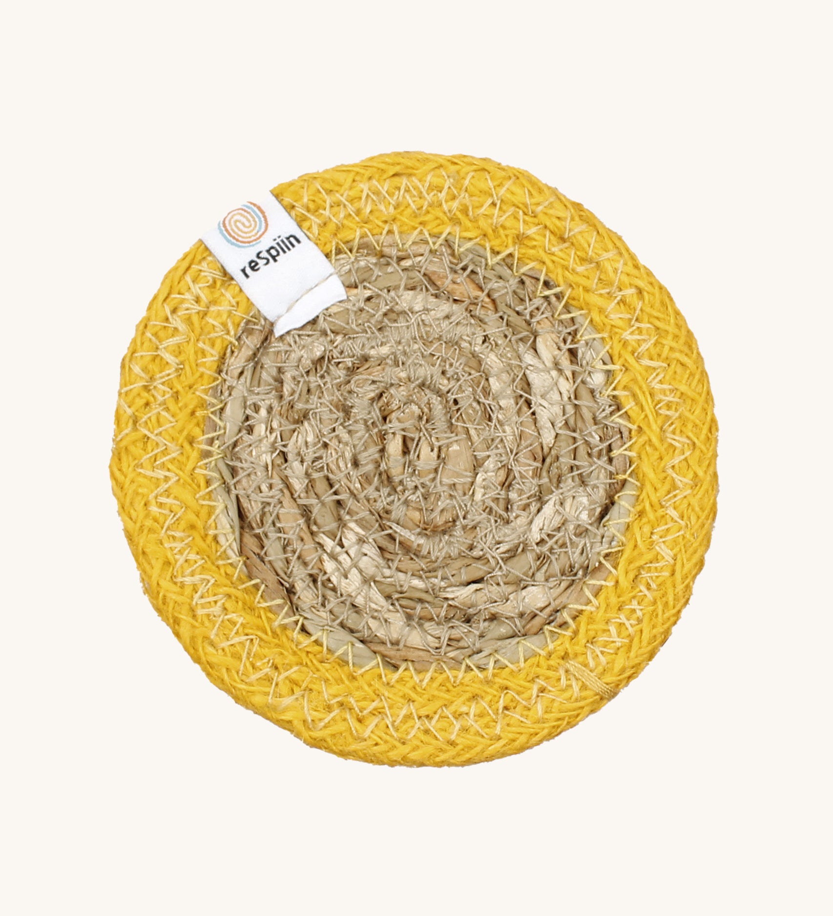 The ReSpiin natural jute and seagrass coaster in yellow.