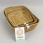 A close up view of the Respiin rectangular seagrass baskets inside eachother  showing the woven detail. 