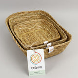 A close up view of the Respiin rectangular seagrass baskets inside eachother  showing the woven detail. 
