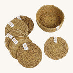 A set of 6 Respiin seagrass coasters in natural with a matching holder. Features a brand patch stitched on the rim.
