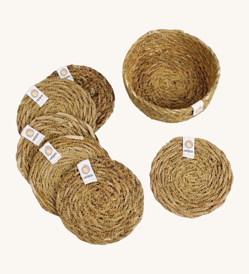 A set of 6 Respiin seagrass coasters in natural with a matching holder. Features a brand patch stitched on the rim.