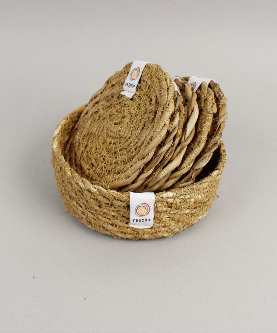 A close up view of the Respiin seagrass coasters inside the matching holder 