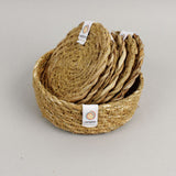 A close up view of the Respiin seagrass coasters inside the matching holder 