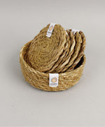 A close up view of the Respiin seagrass coasters inside the matching holder 