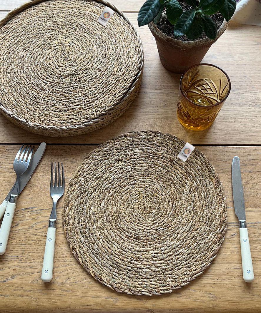 A top down view of the Respiin seagrass tablemat on a wooden table 