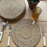 A top down view of the Respiin seagrass tablemat on a wooden table 