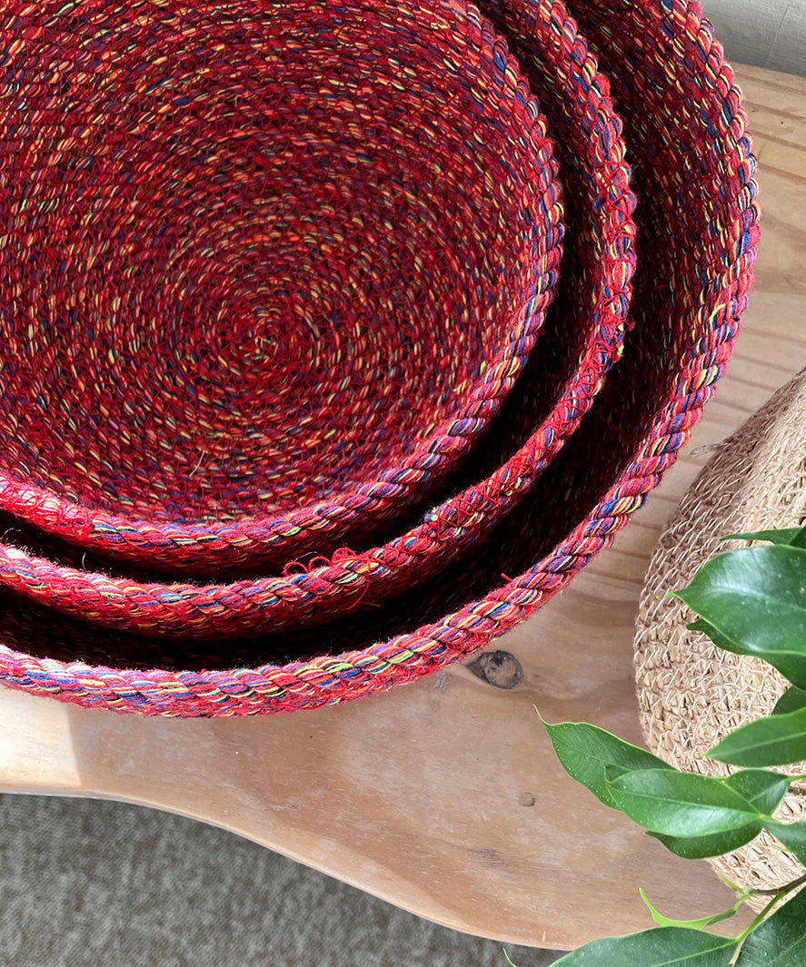A top down view of the Respiin multicoloured recycled cotton bowl set on top of a wooden surface showing the bowls inside eachother 