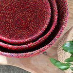 A top down view of the Respiin multicoloured recycled cotton bowl set on top of a wooden surface showing the bowls inside eachother 