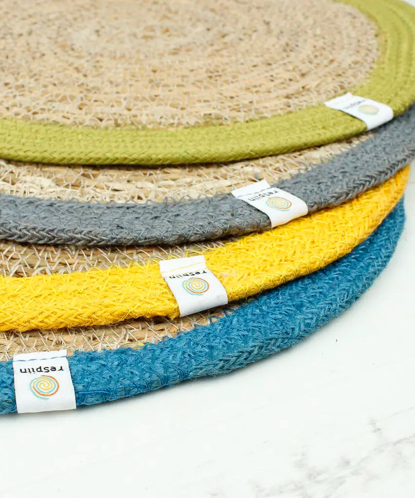 A stack of 4 Respiin jute table mats from different sets showing coloured edging and brand tab 