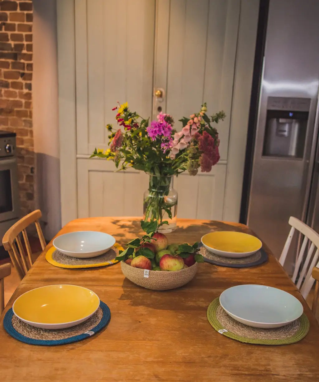 4 Respiin jute table mats from different 6 packs including natural, brights and rainbow sets on a dining table