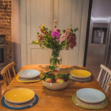 4 Respiin jute table mats from different 6 packs including natural, brights and rainbow sets on a dining table