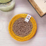 ReSpiin natural jute coaster with yellow  rim on a table 