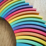 Close-up of a curved rainbow-colored wooden blocks from the Abel blocks mini rewood Rainbow wooden stacking blocks  sets.