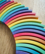 Close-up of a curved rainbow-colored wooden blocks from the Abel blocks mini rewood Rainbow wooden stacking blocks  sets.