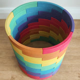 Abel blocks mini rewood Rainbow wooden stacking blocks stacked up to create a cylinder.