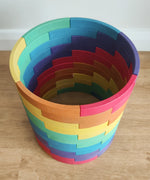 Abel blocks mini rewood Rainbow wooden stacking blocks stacked up to create a cylinder.