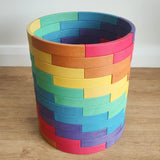 Abel blocks mini rewood Rainbow wooden stacking blocks stacked up to create a cylinder.