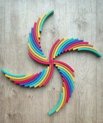 Abel blocks mini rewood Rainbow wooden stacking blocks placed in a pattern on a wooden surface.