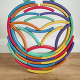 Abel blocks mini rewood Rainbow wooden stacking blocks stacked and balanced on each other.