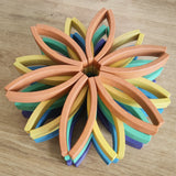 Abel blocks mini rewood Rainbow wooden stacking blocks stacked up in flower shapes in colour order.