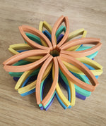 Abel blocks mini rewood Rainbow wooden stacking blocks stacked up in flower shapes in colour order.