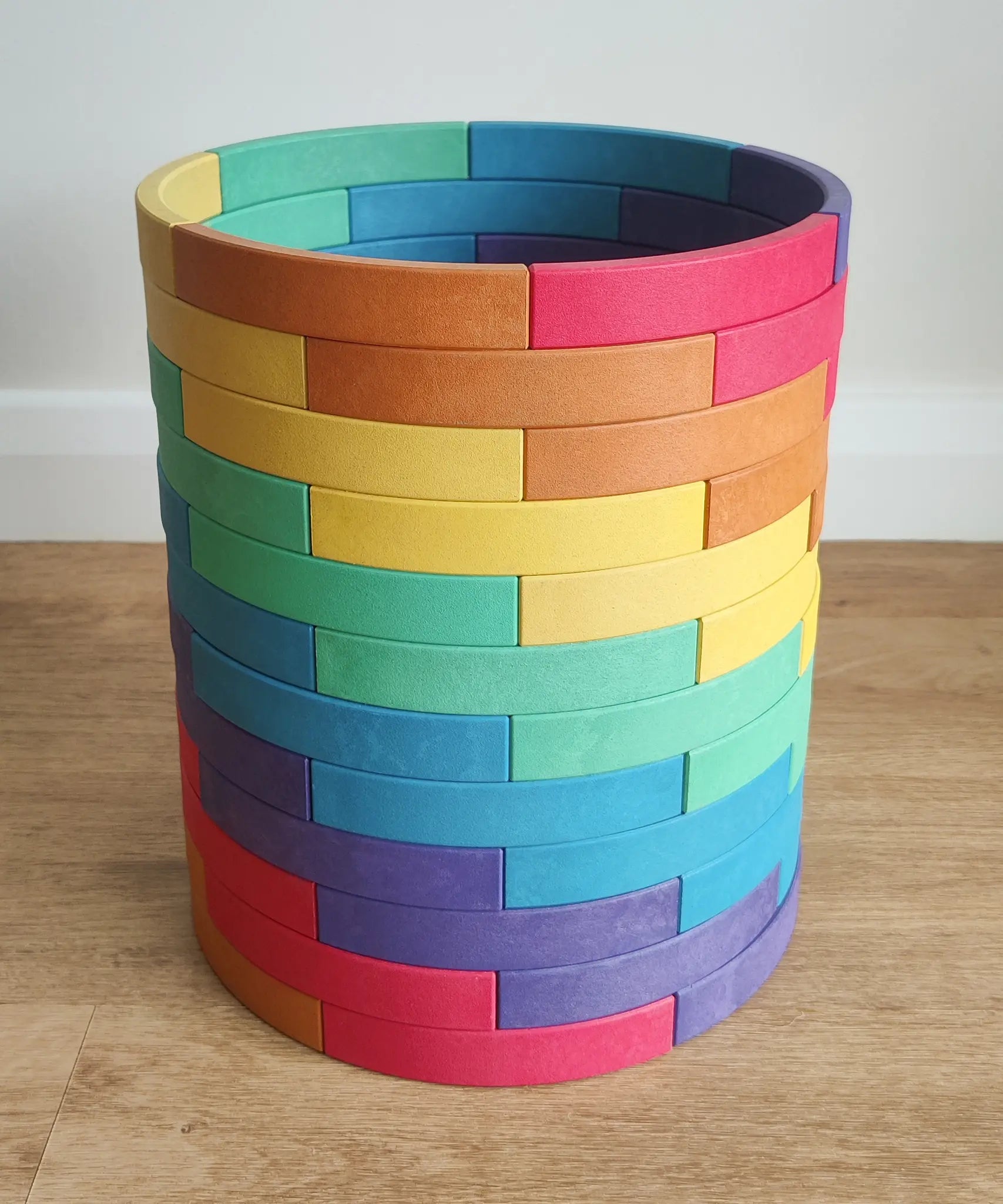 Abel blocks mini rewood Rainbow wooden stacking blocks stacked up to create a cylinder.