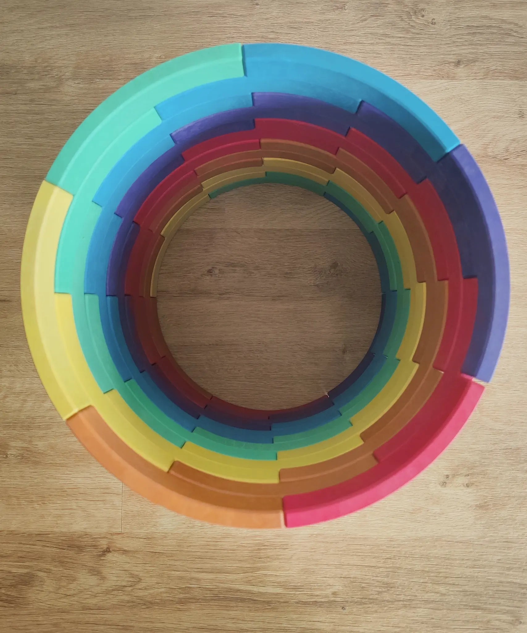 Overhead view of the Abel blocks mini rewood Rainbow wooden stacking blocks stacked up to create a cylinder.