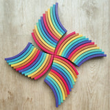 Abel blocks mini rewood Rainbow wooden stacking laid out on a wooden surface.