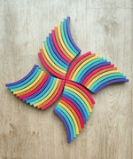 Abel blocks mini rewood Rainbow wooden stacking laid out on a wooden surface.