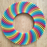 Abel blocks mini rewood Rainbow wooden stacking blocks placed in a circle.