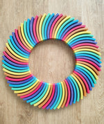 Abel blocks mini rewood Rainbow wooden stacking blocks placed in a circle.