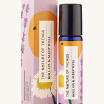 Roll On Sleep Well Essential Oil Blend in a blue glass bottle next to it's decorative pink cardboard box. 