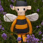 The Roommate Bee Rag Doll placed in the middle of the lavender plant. 