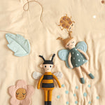 Childrens Roommate eco-friendly soft rag doll bee and butterfly toy laying on a cream duvet set