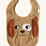 The Roommate Dog Baby Bib with an embroidered puppy face with floppy 3D ears. Cream background.