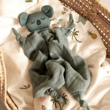 Roommate eco-friendly soft koala baby comfort blanket laid out on a white duvet in a moses basket