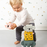 A child playing with the Roommate Jungle Life Stacking Blocks.